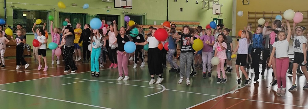 dzieci tańczą na sali sportowej 